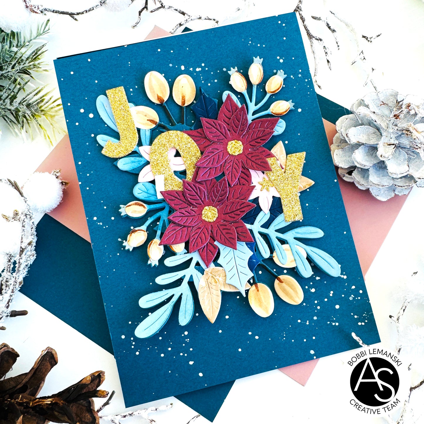 Decorative card with floral designs and 'JOY' text on a blue background, featuring the alex syberia designs products