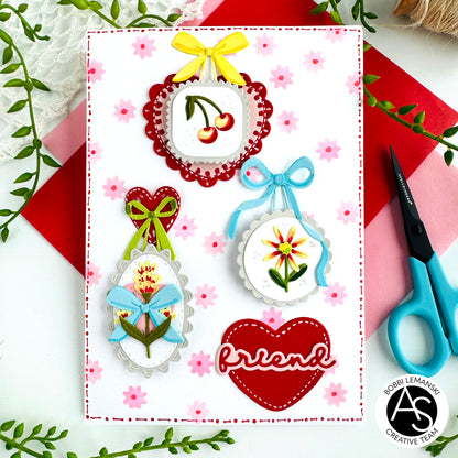 Decorative card with embroidered designs and 'friend' text, featuring Alex Syberia Designs medallions on a floral background.